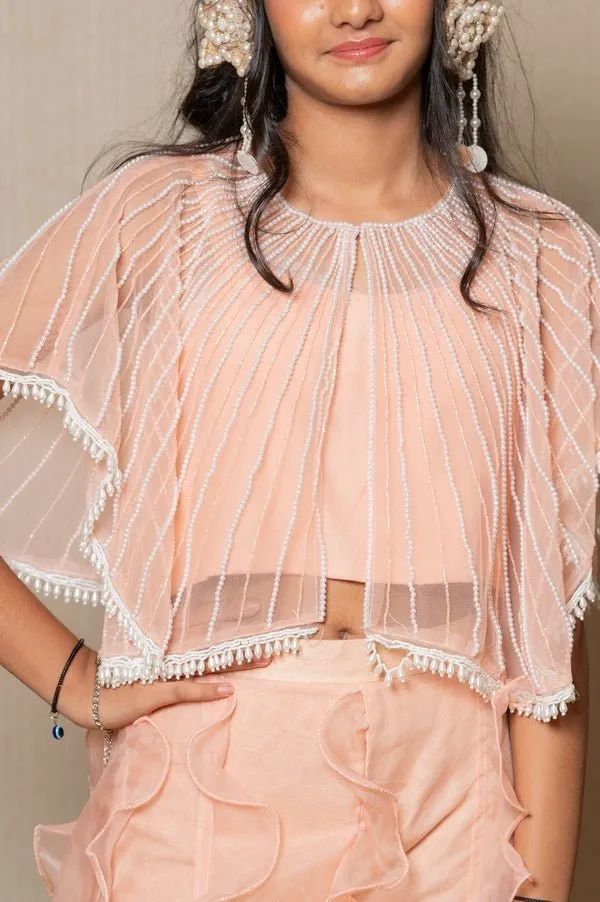 Chic Peach ensemble with beaded cape and ruffled palazzo pants, perfect for a stylish and elegant look at any occasion.